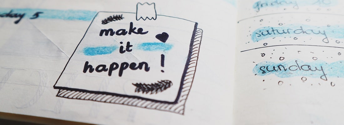 Page d'un agenda sur laquelle il est écrit "Make it happen"